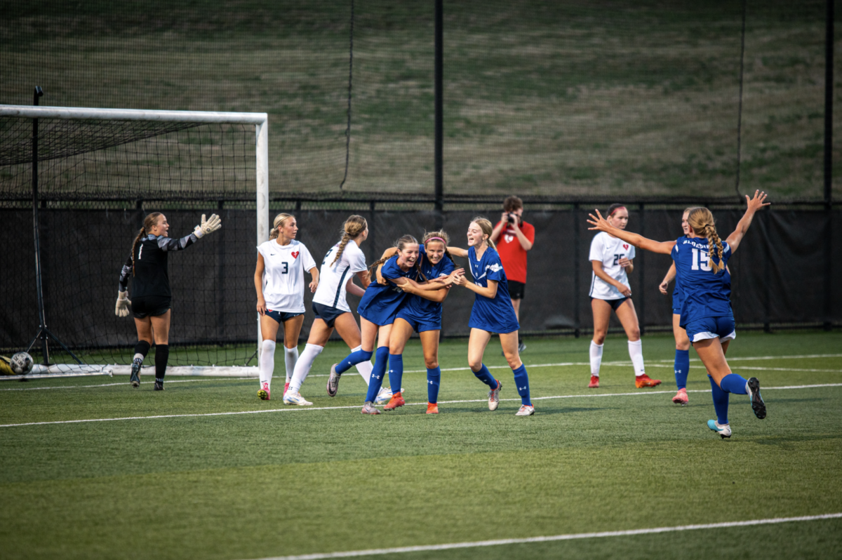 Tenley Graves (11), Franny Smith (11), Macy Hargis (11), and Katie Bucher (11) celebrate after Graves scored the goal to tie the game in the second half. 